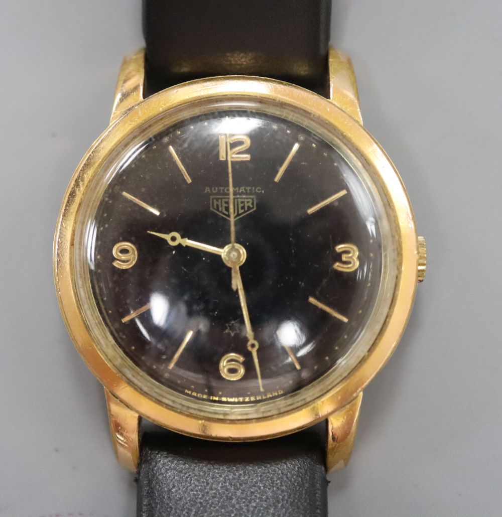 A 1960s? steel and gold plated Heuer black dial automatic wrist watch, on later associated strap.
